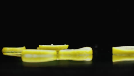 Lemon-rings-sliced-fall-on-the-glass-with-a-splash-of-water.